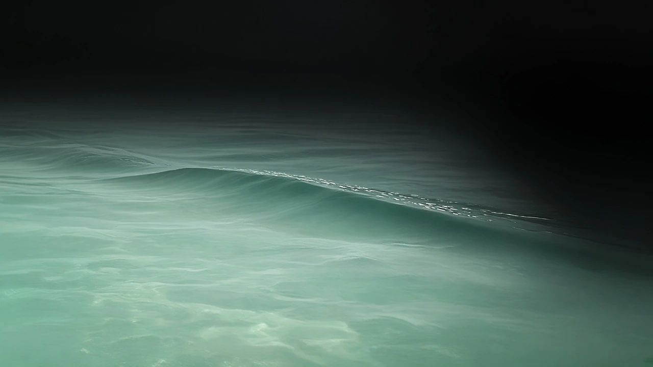 A long pale swell on an empty sea at noon, with no horizon.