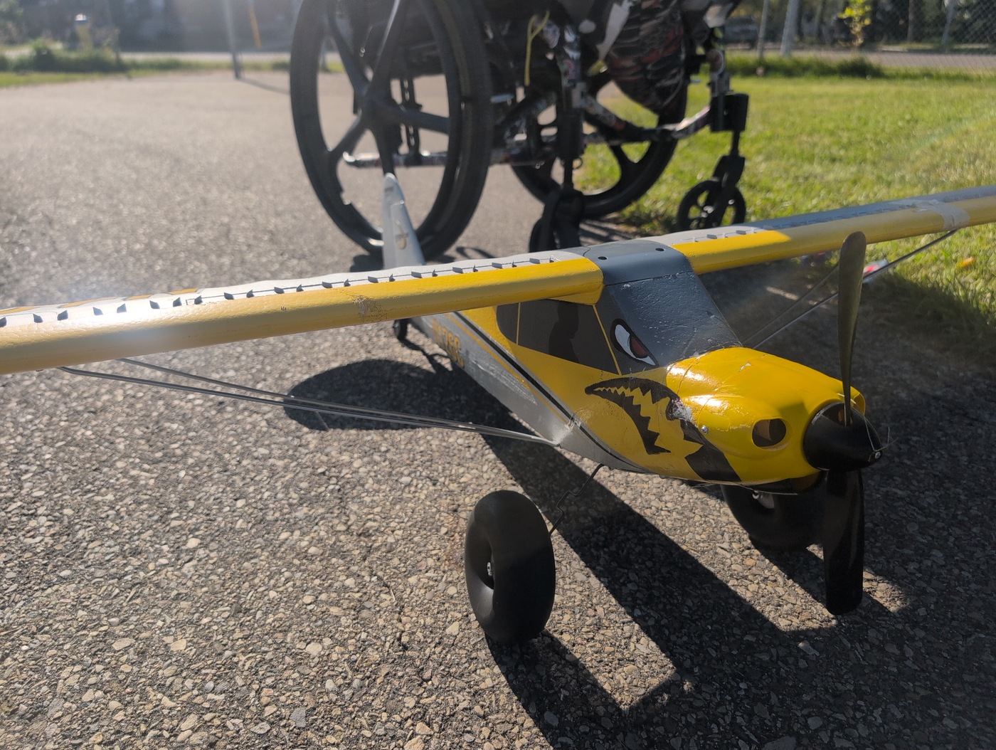 Close up of hands working on the fuselage of the RC plane